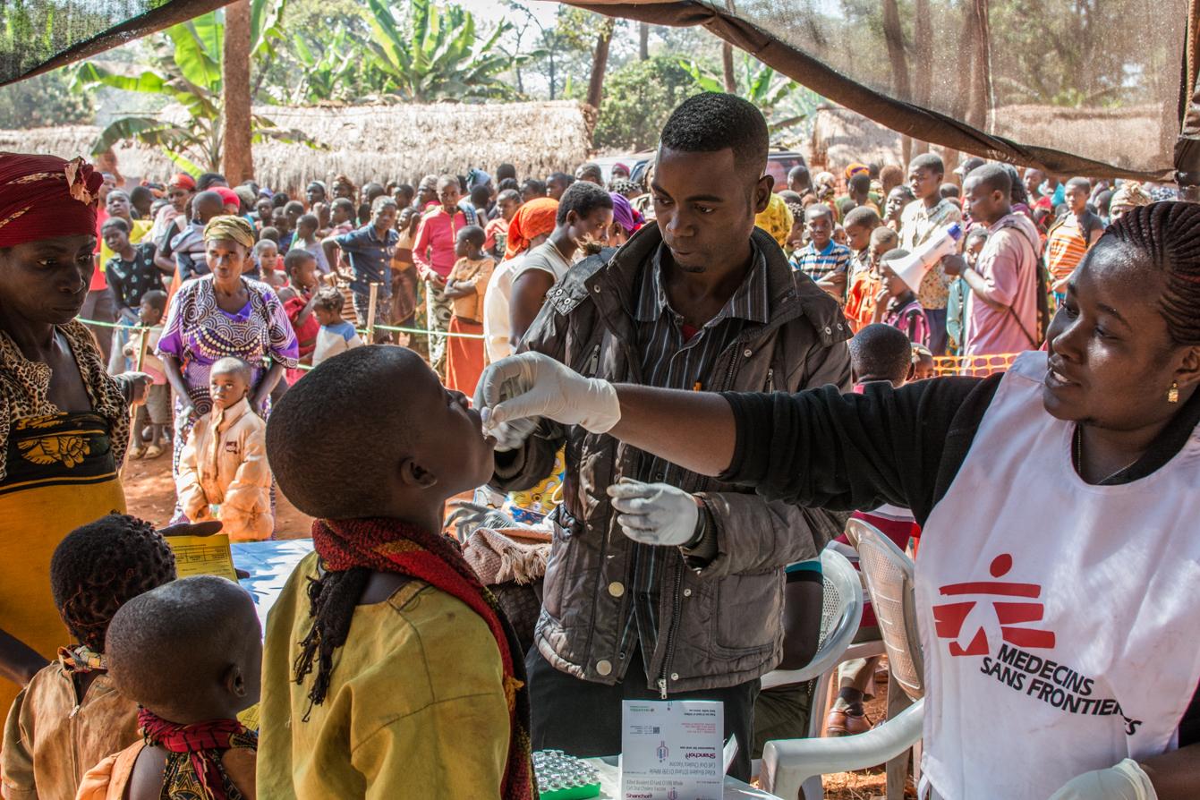 MSF Staff administrating an oral vaccine to a boy at the Nyaragusu refugee camp, Tanzania