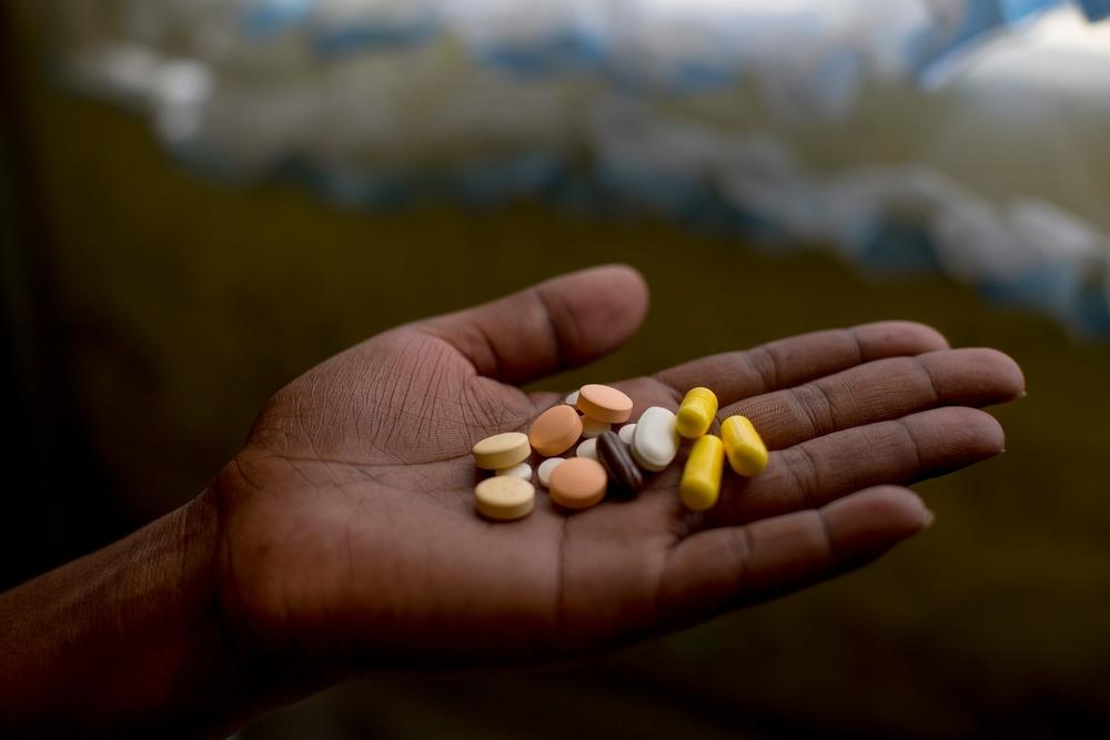 Patient Nanyanyiso Baloi holds her treatment regimen for pre-XDR-TB, which includes delamanid and bedaquiline. Khayelitsha, Western Cape.