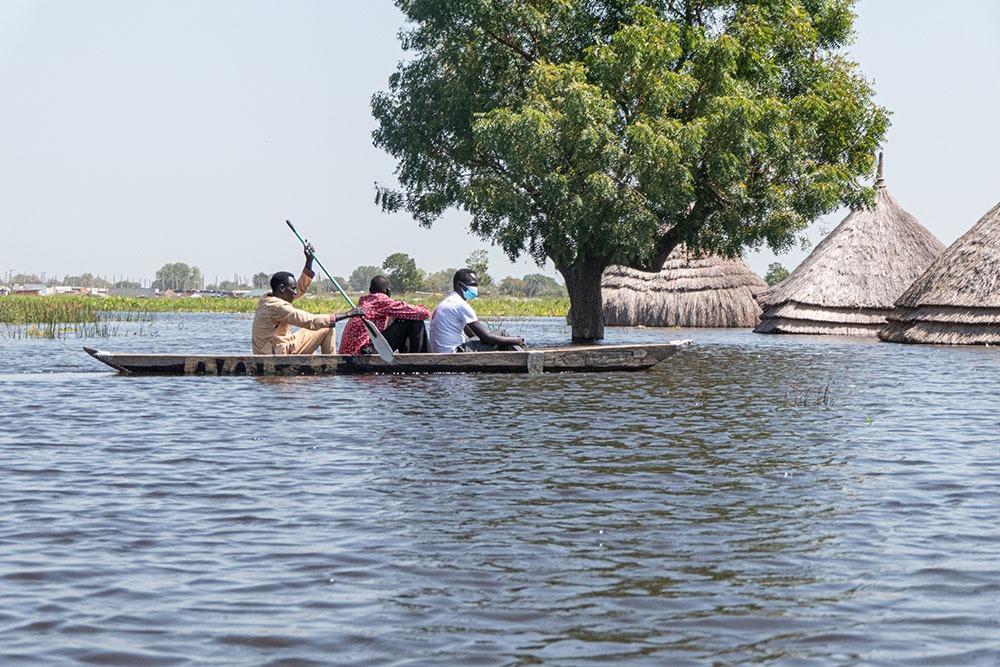 Men in a canoe navigate the flood waters in Bentiu, Unity state, South Sudan