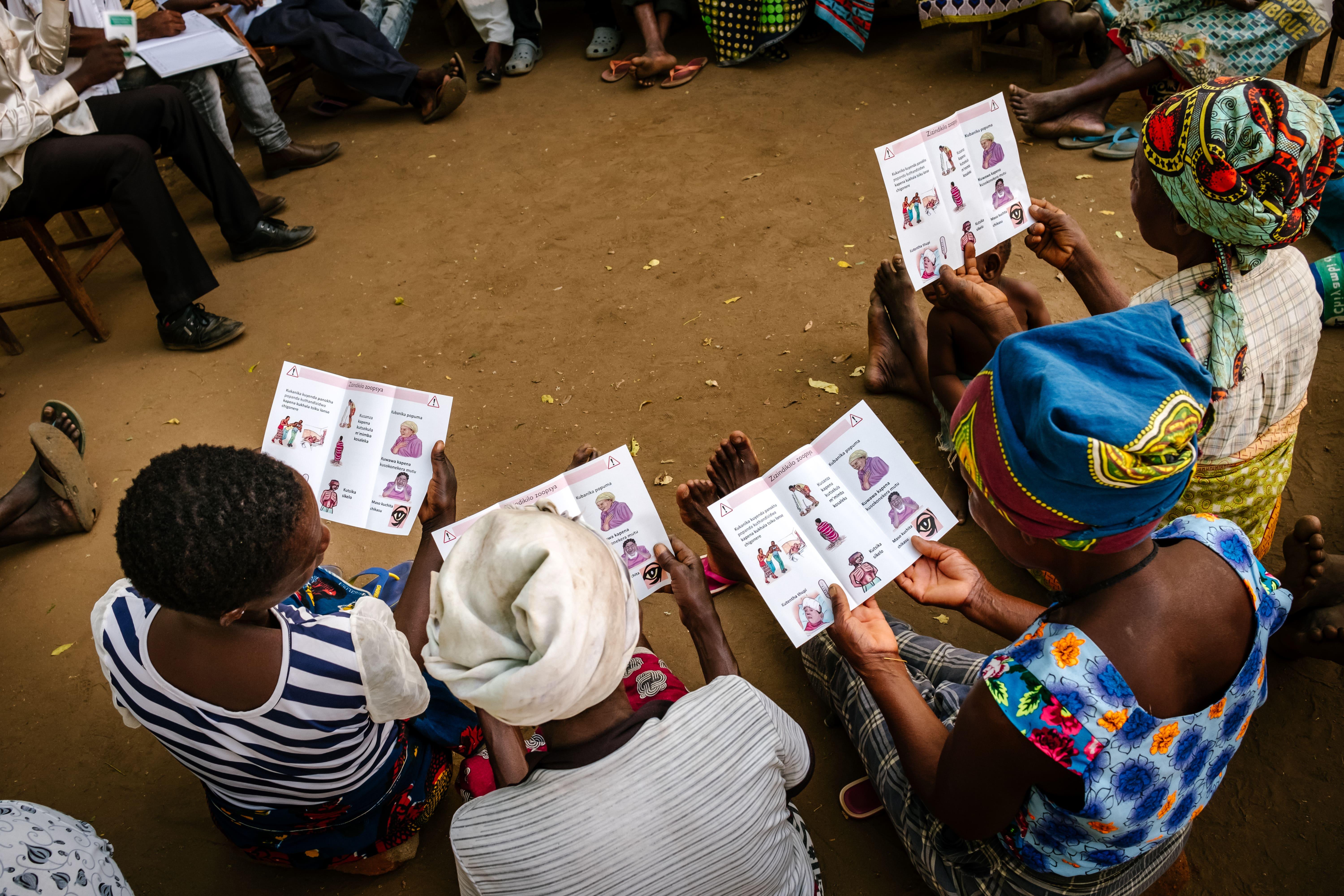 Members of the support group at Ndamera Health Centre in Nsanje district going through some educational brochures provided by MSF health promoters for advanced HIV