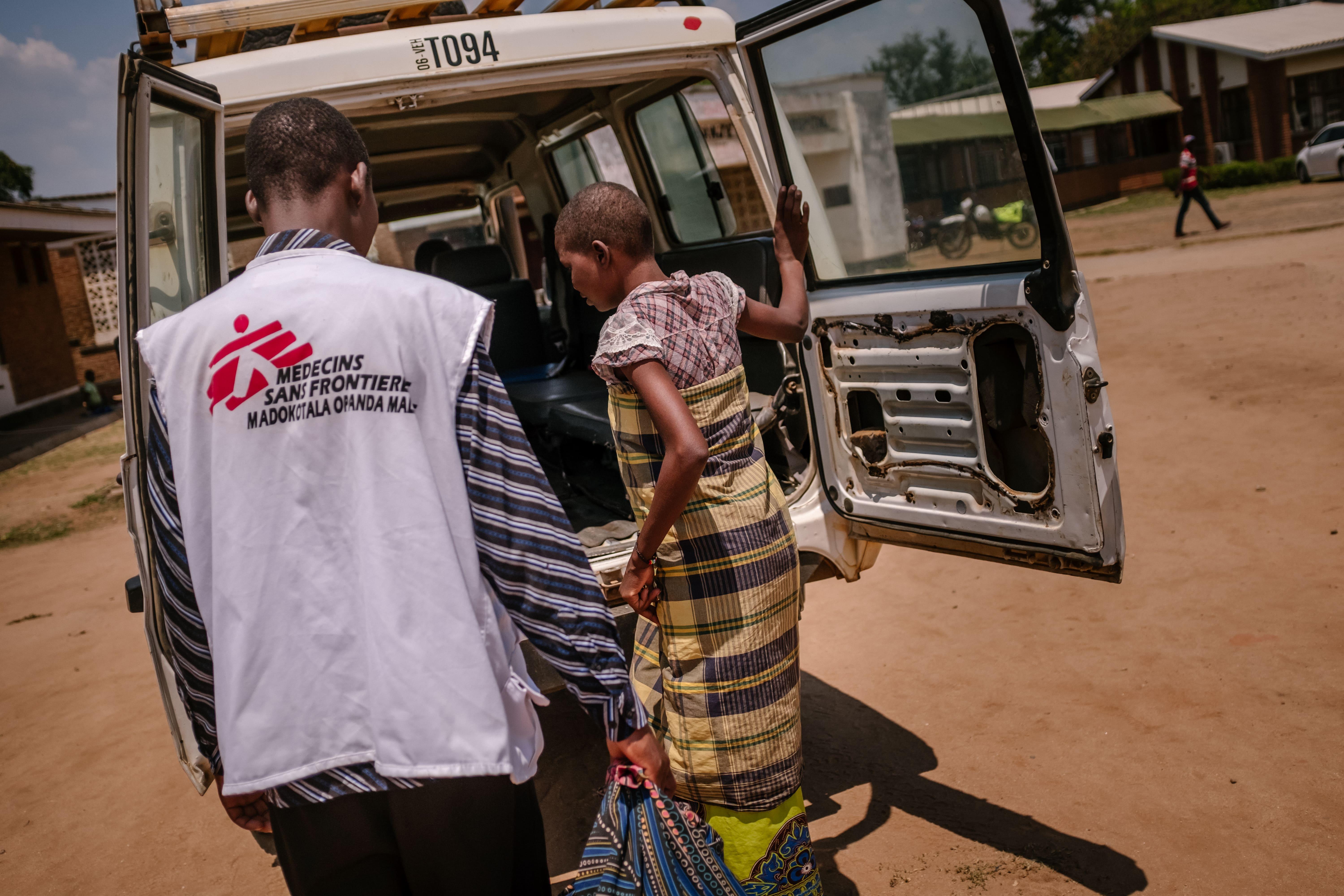 Esther, an advanced HIV patient, boarding an MSF vehicle after being discharged from Nsanje District Hospital.