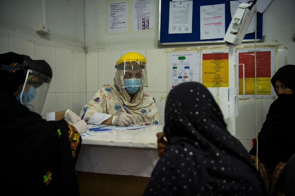 A photo of Mrs Khadija, an ER nurse, speaking to patients  Boost hospital, Helmand's primary provincial hospital in the capital Lashkar Gah