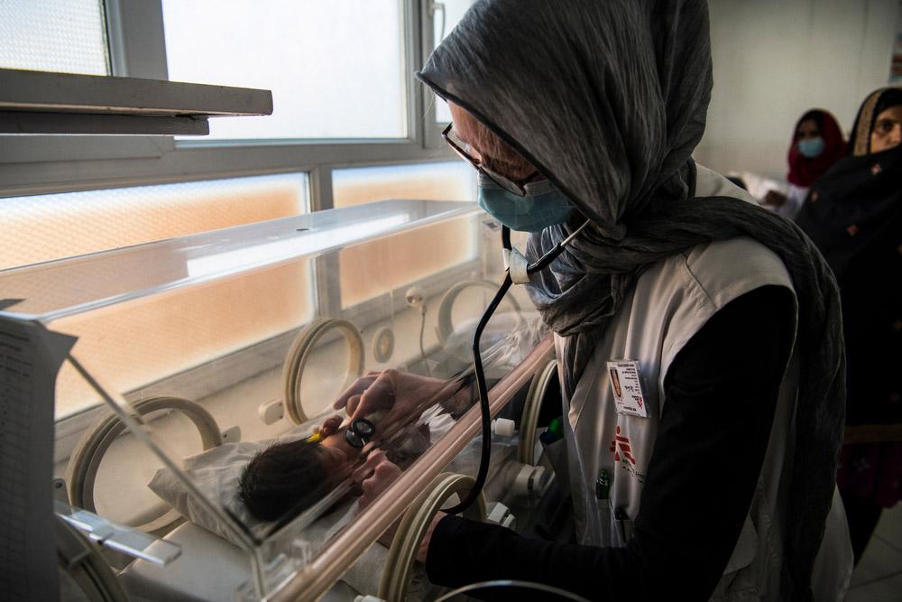 A picture of Dr Lia, a paediatrician, examining a baby in the neonatal intensive care unit (NICU) at Boost hospital, 