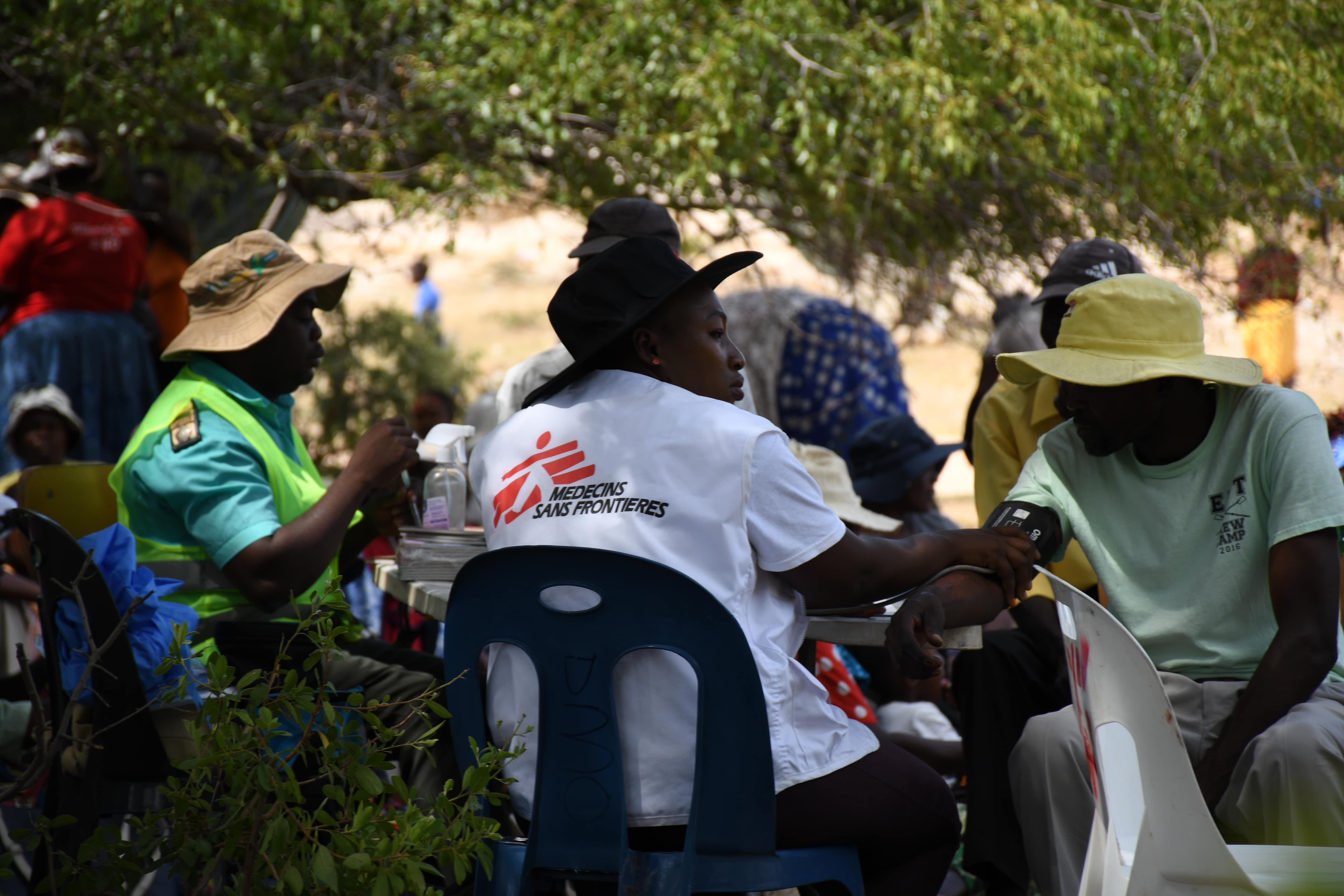 Artisanal Miners in Zimbabwe: MSF staff taking patient's blood pressure.