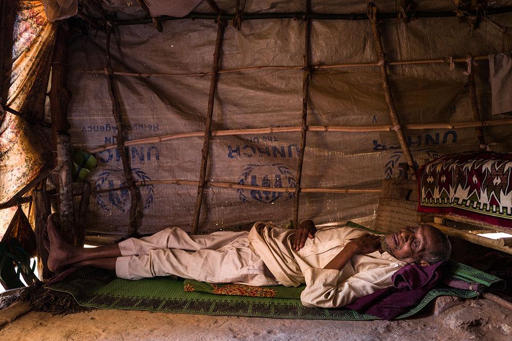 Yougouda Bangbagui, 73, lying down in his tent in the Central Mosque of Bambari. He is quite sick and the hardest thing for him is feeling useless. 