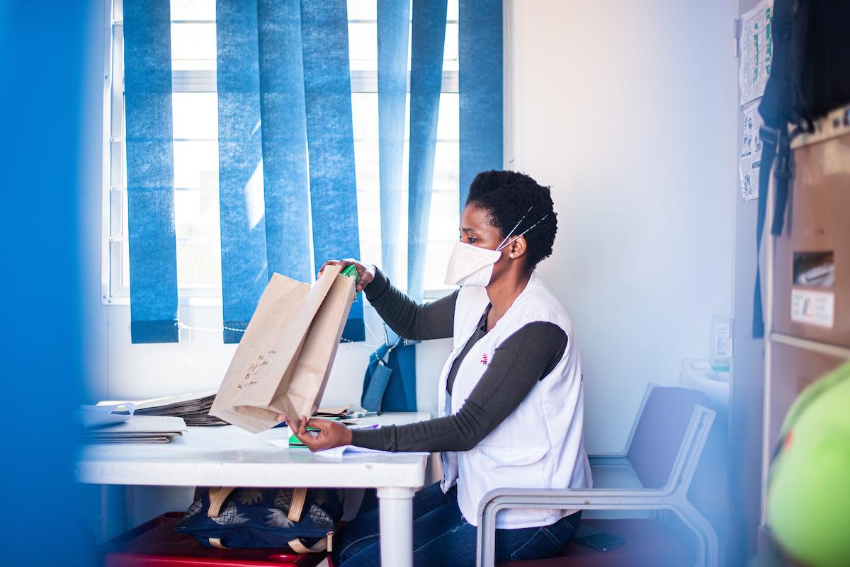 Pharmacy assistant bagging medicine