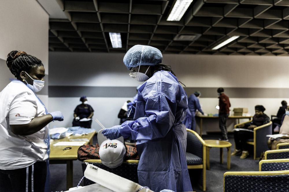 A picture of Bhelekazi Mdlalose and another MSF staff member doing COVID-19  health promotion in Johannesburg, South Africa.