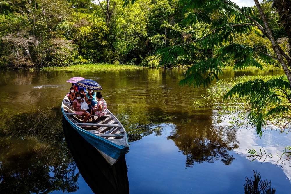 Patients on a boat arriving at the primary healthcare centre in Tefe