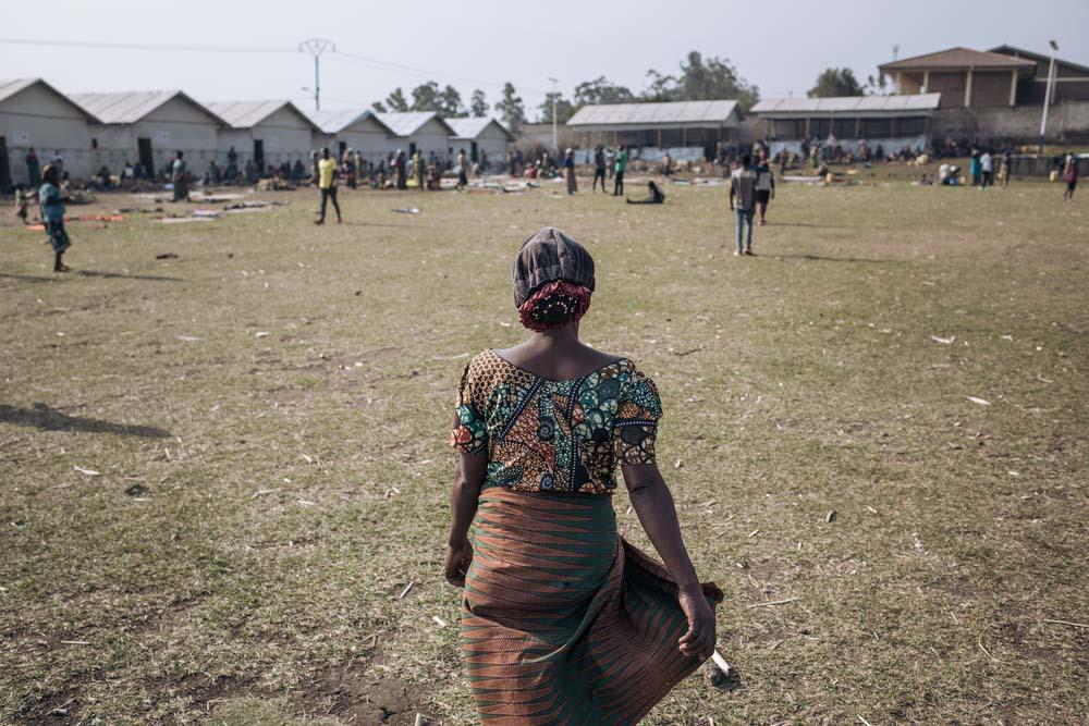 Agrippine, a 53-year-old displaced widow, walks in the informal IDP site of Rugabo Stadium in Rutshuru Centre, in North Kivu province, eastern Democratic Republic of Congo