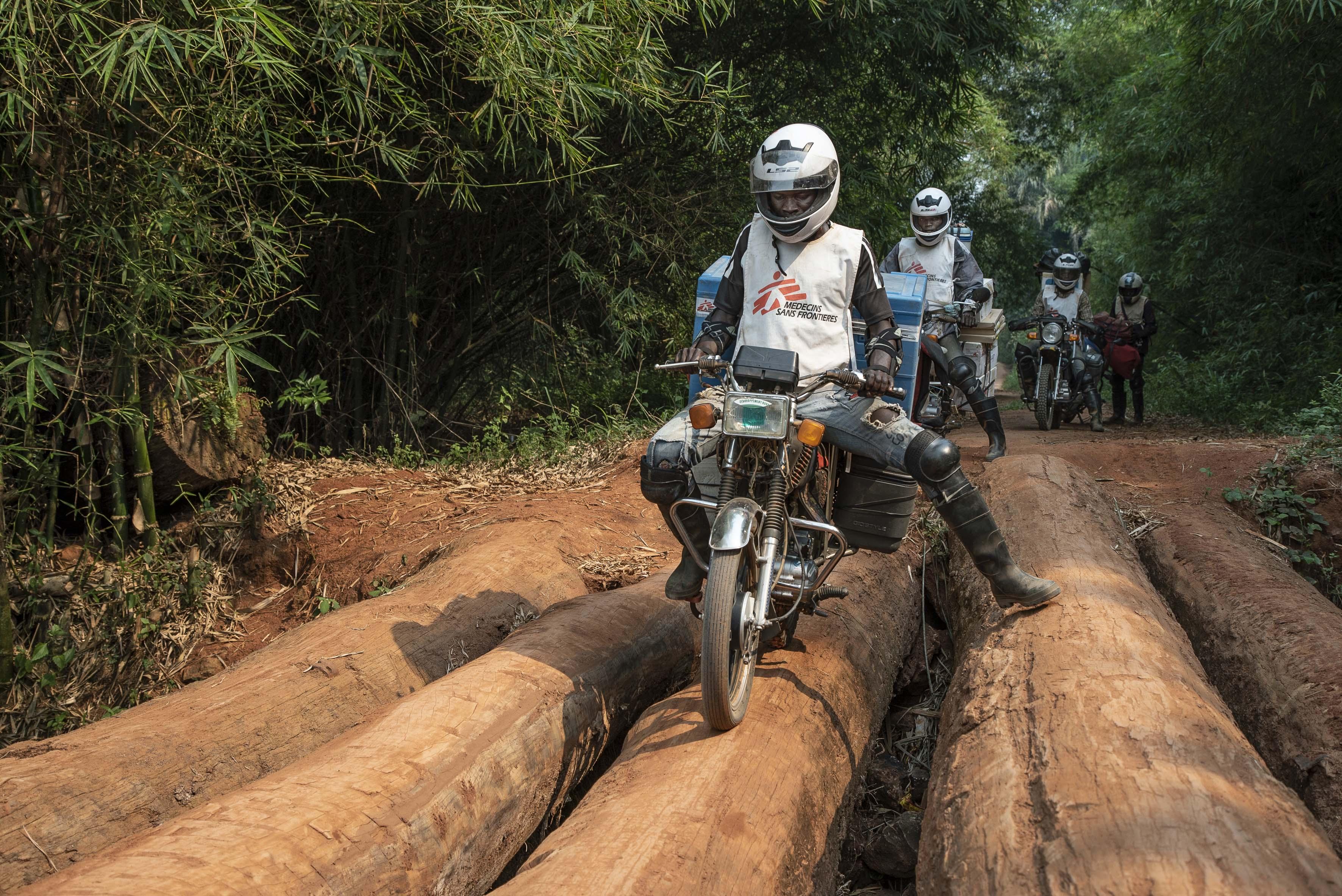 Measles vaccines being delivered by motorbike from to Boso Manzi, Mongala province. DRC 2020