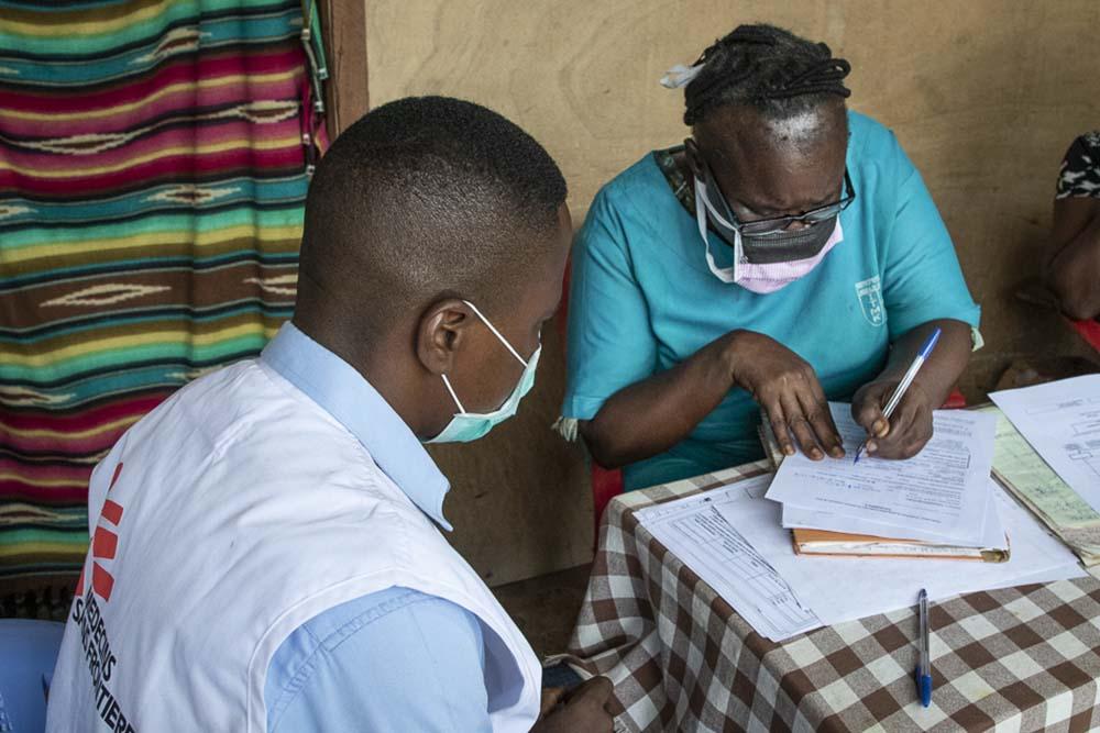 Picture of Epidemiologist Gaston Musemakweli trains Marguerite Bekayi Bonpango, supervising nurse at the "Le Temps du Soir" health centre in Mbandaka
