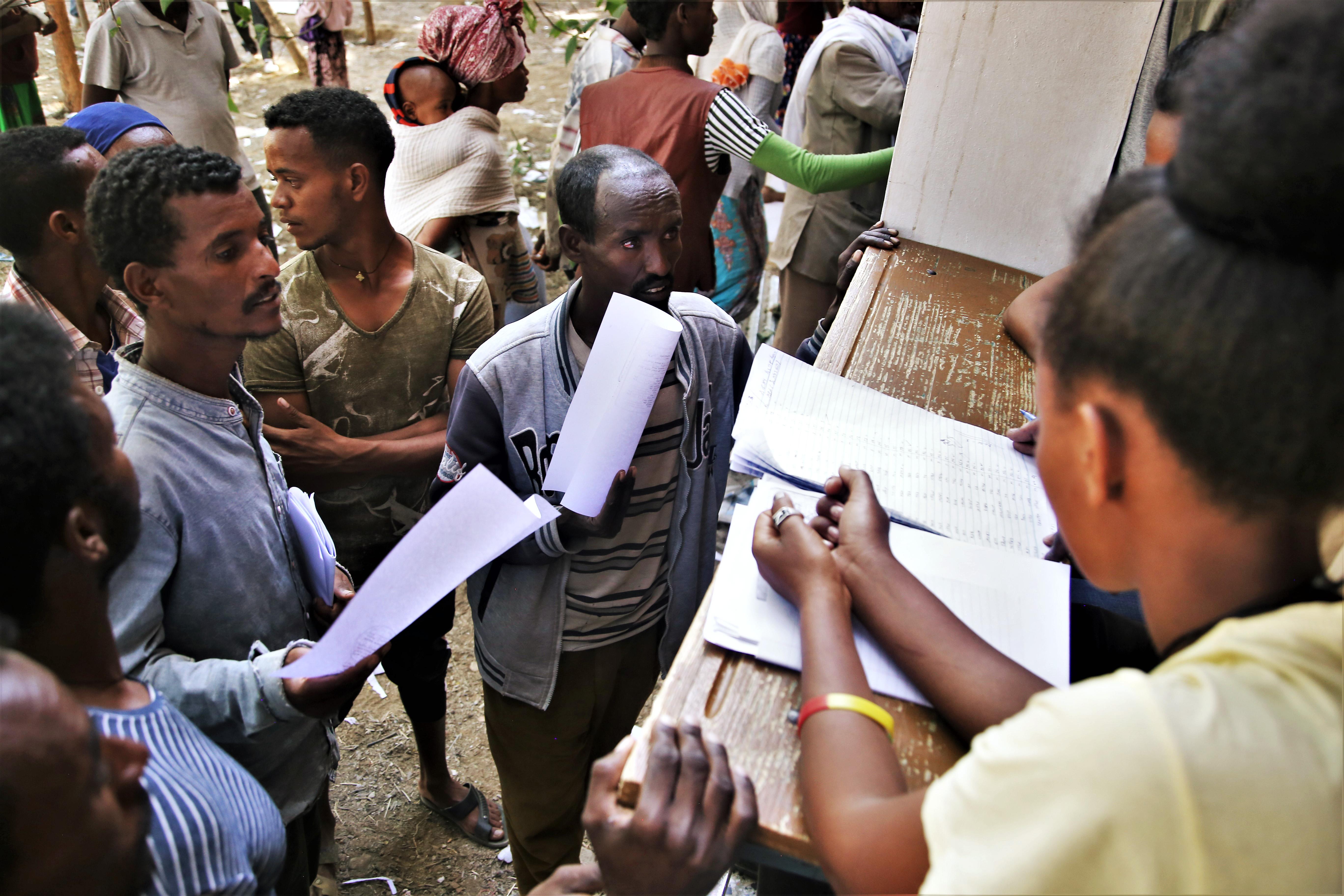 Administrators register newly arrived displaced people at Tsegay Berhe school, in the city of Adwa in central Tigray, northern Ethiopia. 