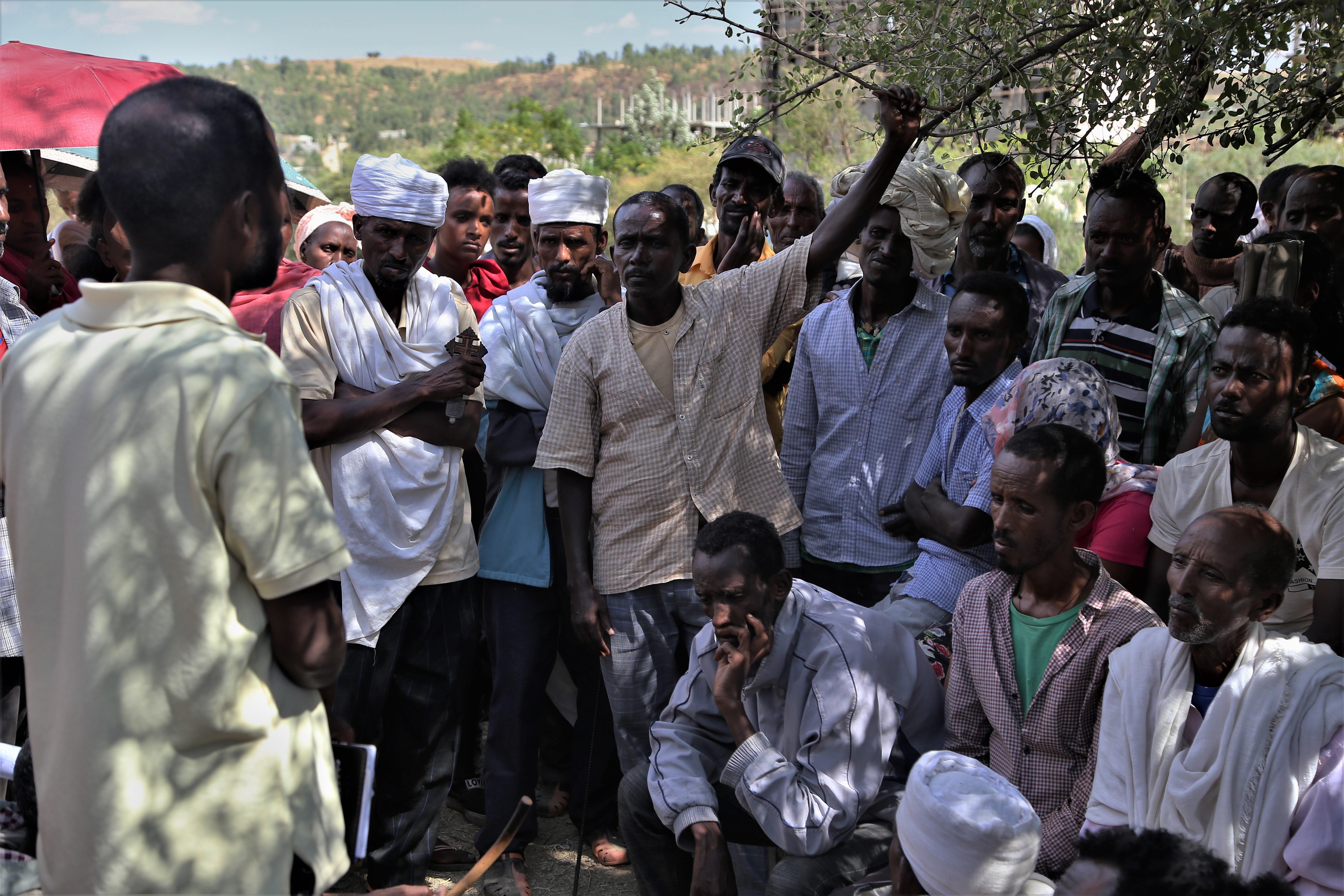 A group of displaced people engage in a discussion at Abdimalaha school in the city of Adwa, in central Tigray. 2021
