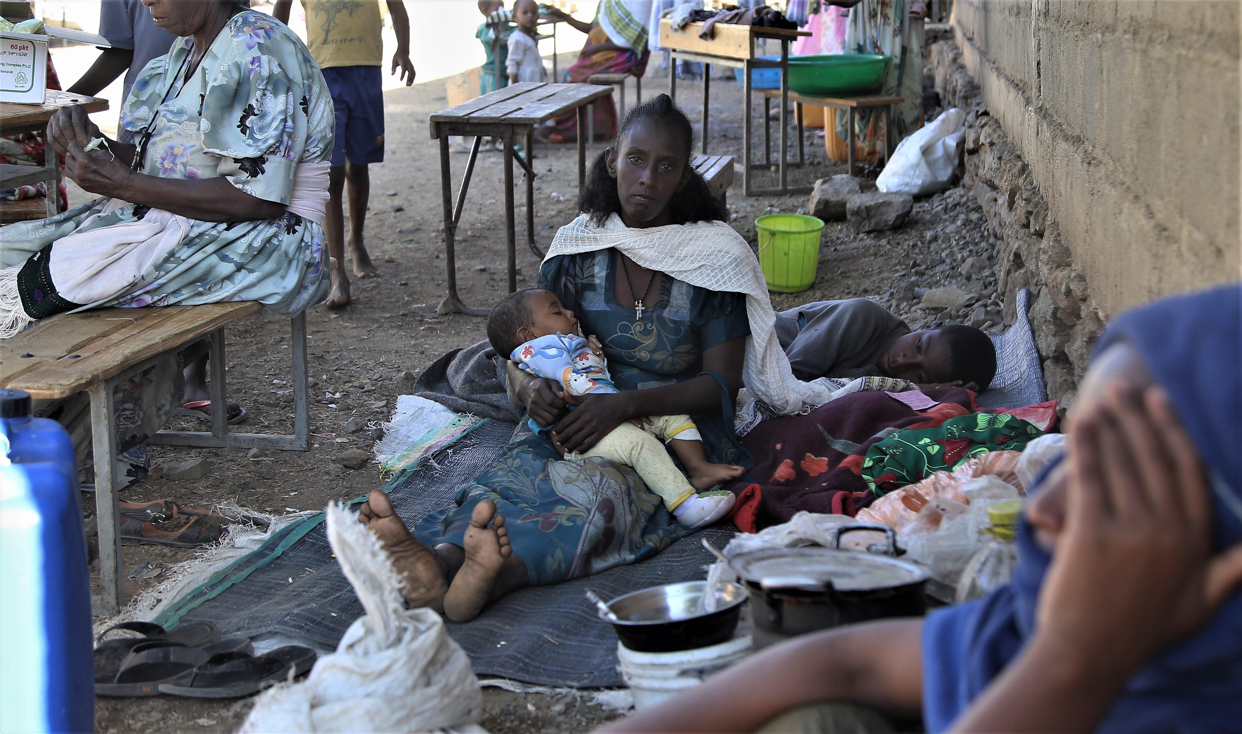 Haragu Masfem, 40, a mother of five, sits outside of the Basin school in Axum, a city in central Tigray that has received thousands of displaced people over recent weeks. 