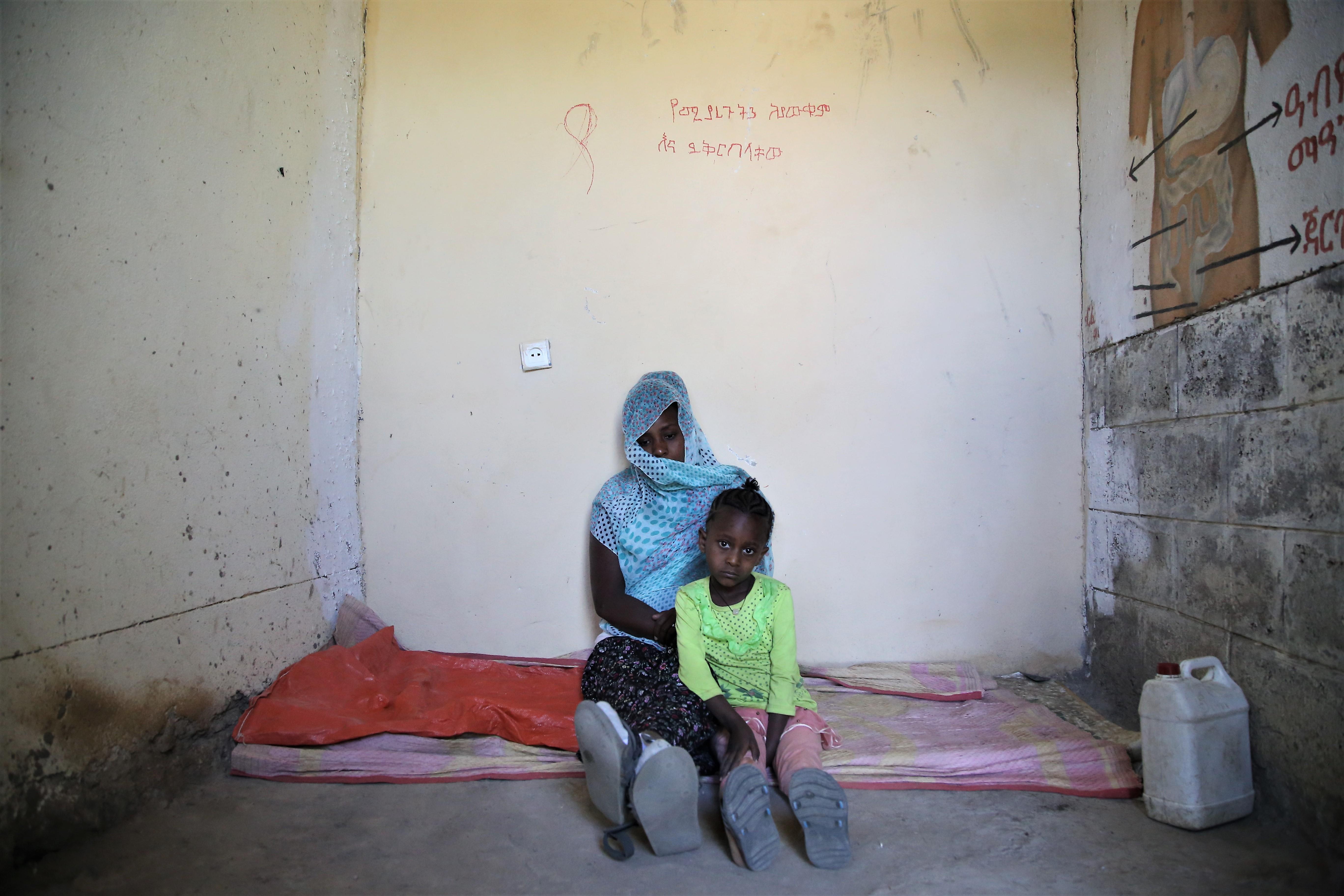 Leterbrhan (pseudonym) lies with her five-year-old daughter in a small room where around 20 people sleep at the elementary school in Abi Adi, a town in central Tigray. Schools have become informal settlements for displaced people fleeing the conflict in this northern region of Ethiopia. 