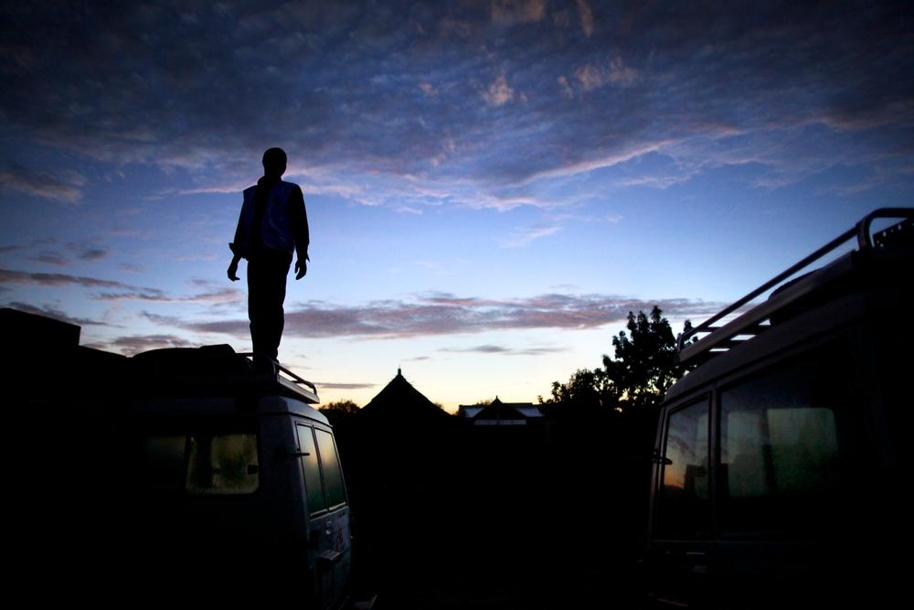 MSF staff member standing on an MSF vehicle while on a mission to reach people with sleeping sickness.