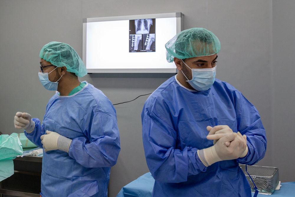 MSF surgical team in the OT performing an intervention on a patient wounded in the Great March of Return protest, February 2020, Al Awda Hospital, Jabalia, northern Gaza.