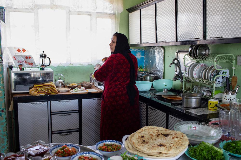 Mohamad’s wife, is preparing for a family lunch in her house’s kitchen