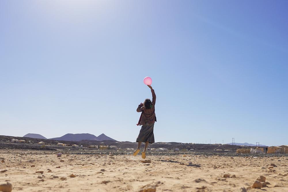A child plays with a balloon at Al-Sweida camp