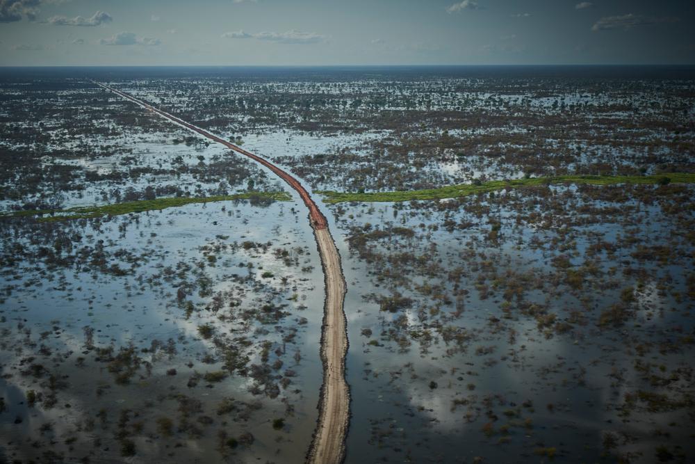 An aerial view of a road and dykes being built