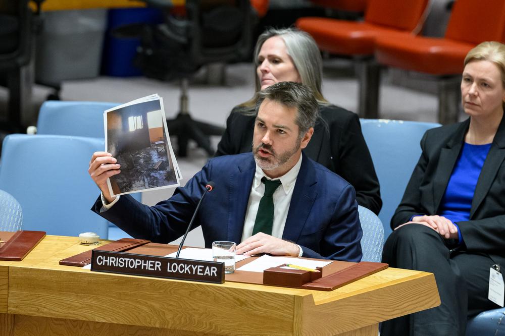 MSF’s Christopher Lockyear holds up an image of the destroyed MSF shelter in Al-Mawasi in Khan Younis, Gaza. Attacks on medical care are devastating