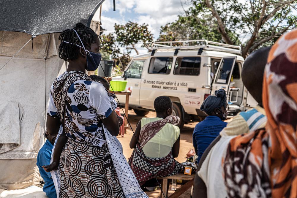 A woman and her child living in a camp