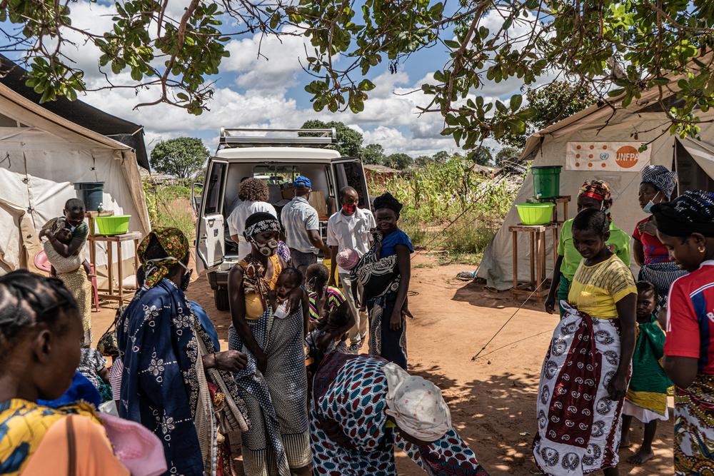 Mothers and children are seen queuing outside of a mobile hospital where MSF and MOH are working in Nicuapa camp for internally displace people who have been forced to flee their homes as a result of armed conflict in Cabo Delgado.