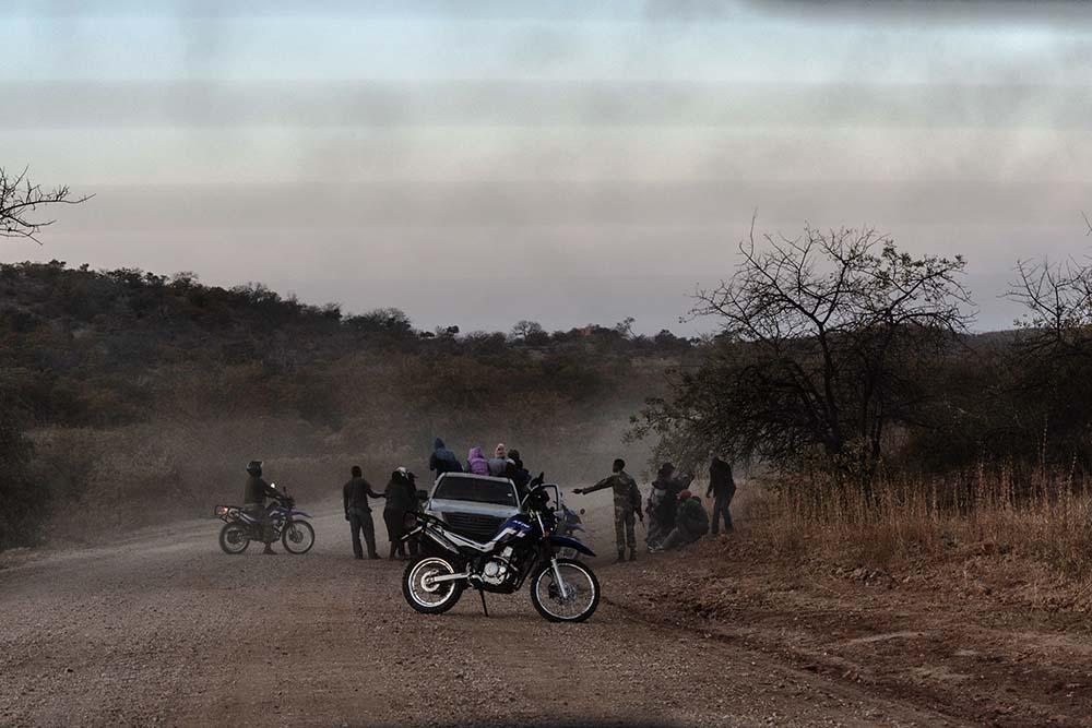 South African soldiers detain a group of people suspected of having illegally crossed into South Africa at the border between South Africa and Zimbabwe.