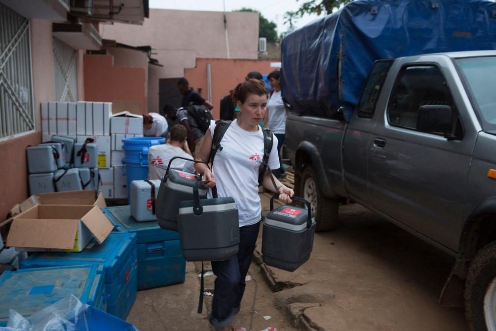 A Medecins Sans Frontieres (MSF) staff member carries cold boxes containing yellow fever vaccines on the first day of the vaccination programme in Matadi, DRC.