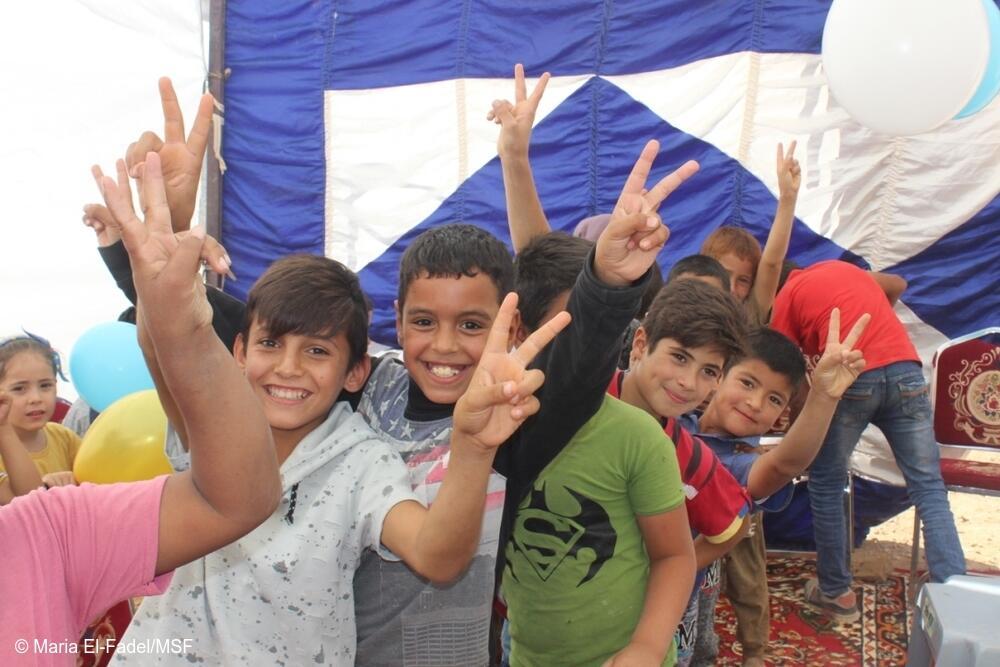 Child health: A group of boys smile and give the peace sign