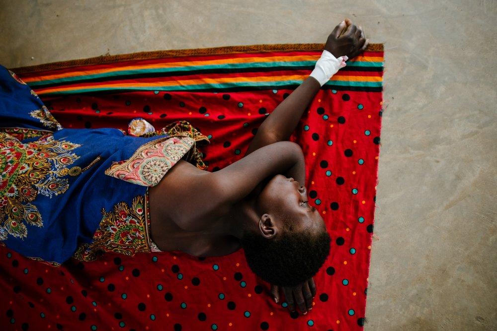 Advanced HIV patient lying on a cloth on the ground