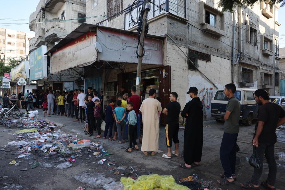 Image showing people queueing to buy food in Gaza. The total blockade has cut off all entry of food into the Gaza Strip.