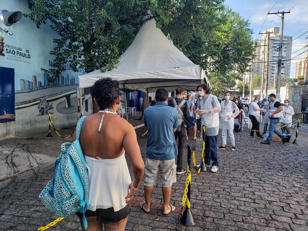 Homeless people standing in line for evaluation and COVID-19 screening