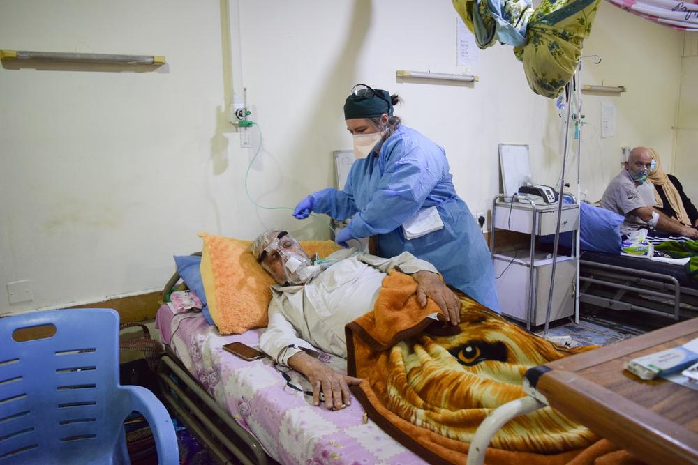 MSF staff with a COVID-19 patient at Al-Kindy hospital, in Baghdad Iraq
