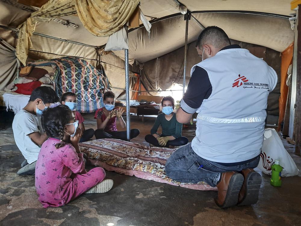 MSF staff conducting a COVID-19 health promotion activity with children in a Palestine village