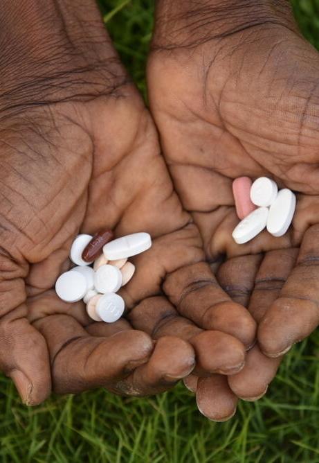 A variety of pills for the treatment of drug resistant tuberculosis are held in two upturned hands. Antibiotic resistance is on the increase.