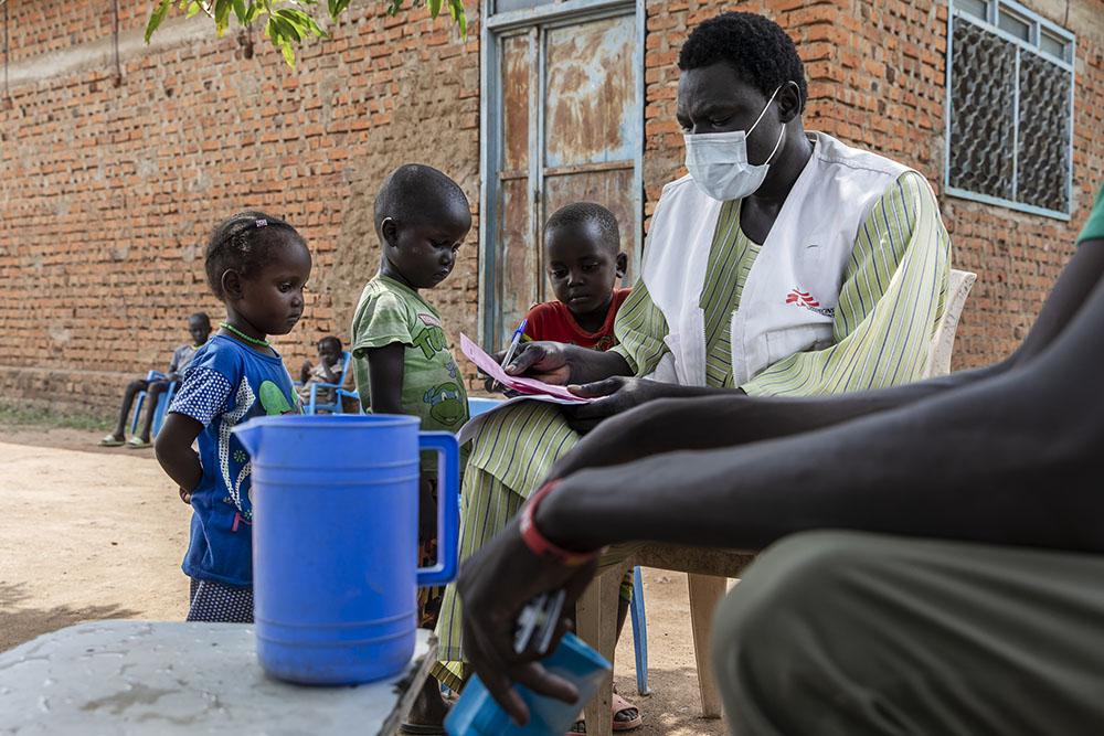 Children of Amoth Wed Duang (Athian, Akoi and Mayen) receive the SMC medication from MSF staff, outside of her home nearby the village Kuom, South Sudan, October 26th, 2021. 