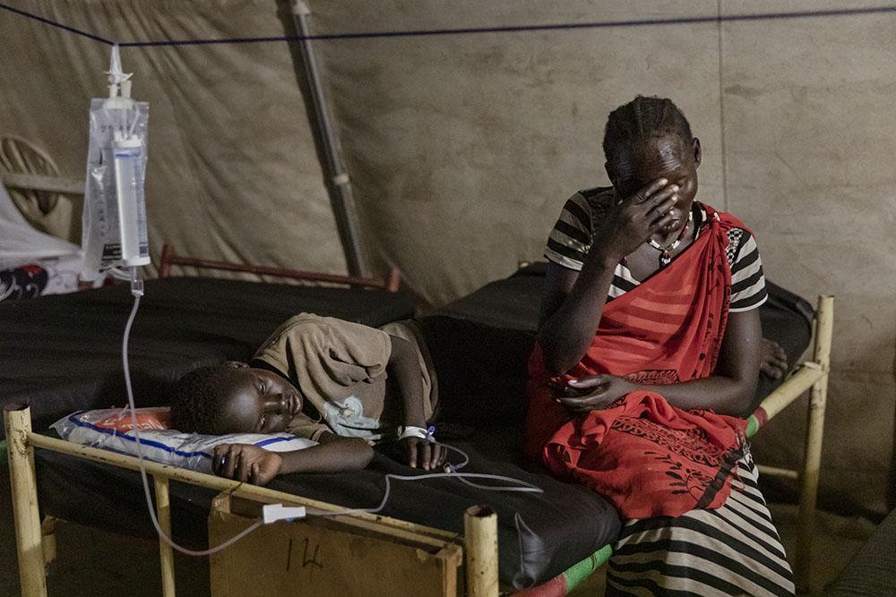Young Zara (age unknown), infected with malaria, and her worried mother, 35-year old Elizabeth Thom, in MSF supported Aweil State Hospital, South Sudan, October 28th, 2021. 