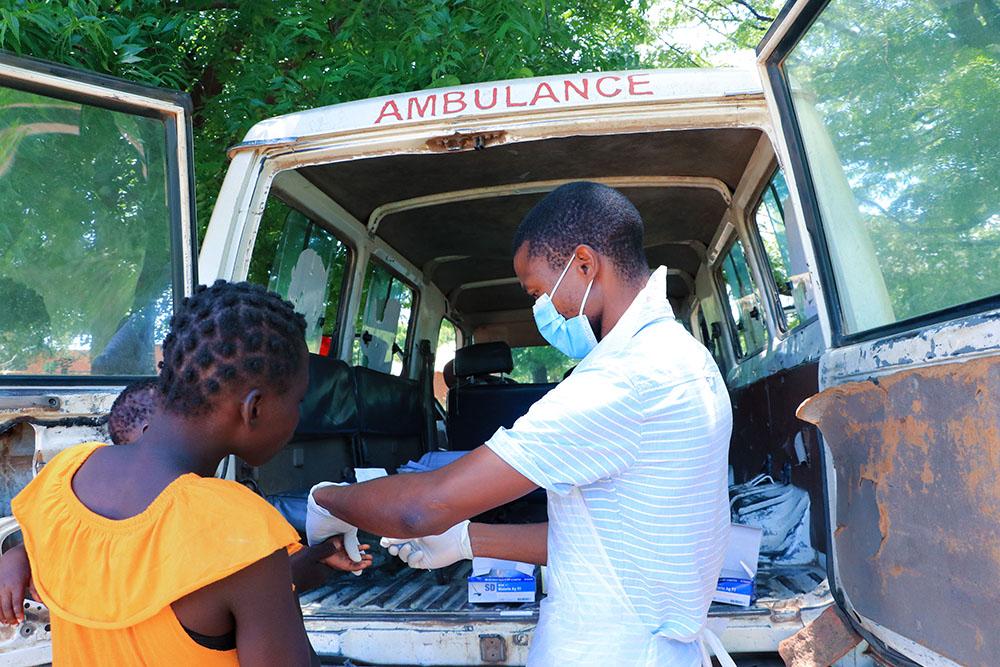 Simeon Maleka from Ministry of Health is seen assisting a patient at a mobile clinic at Kampata in Nsanje where MSF is providing technical support for people displaced by Tropical Cyclone Ana. MSF is providing drugs through Ministry of Health. 