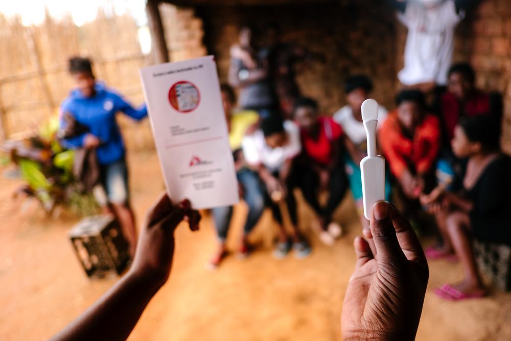 A picture of a woman holding an HIV self test
