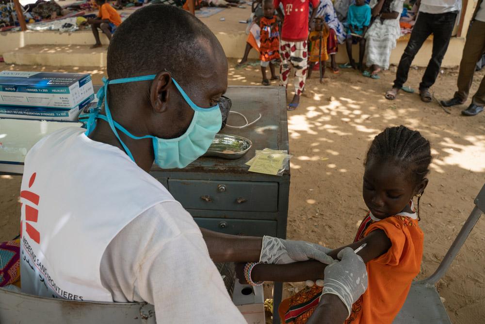 Child being vaccinated against measles in Mali