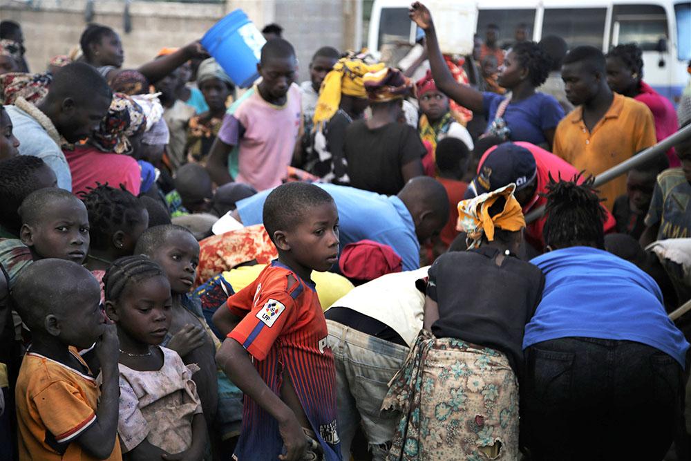 Children observe a water distribution organised by MSF on the outskirts of Mueda, a town in the northern Mozambican province of Cabo Delgado, where hundreds of newly arrived displaced people have been temporarily relocated by the authorities. 