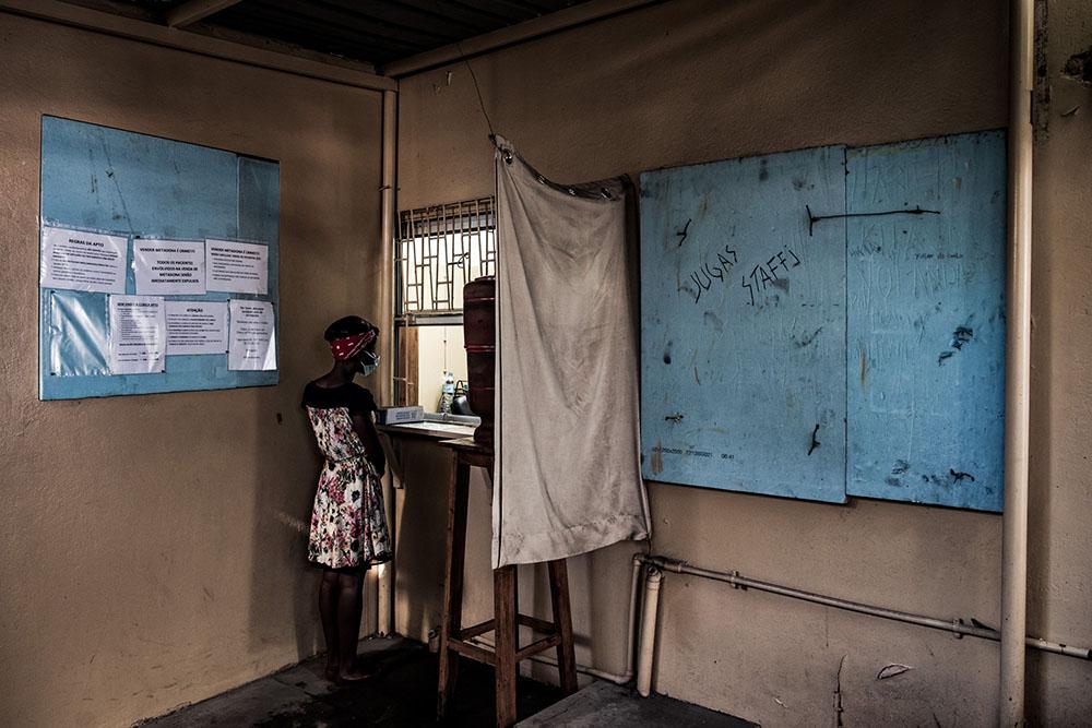 A patient of MSF's methadone programme waits for a nurse to prepare her dose at the Alto-Maé health centre in Maputo, Mozambique, on 22 June 2021.
