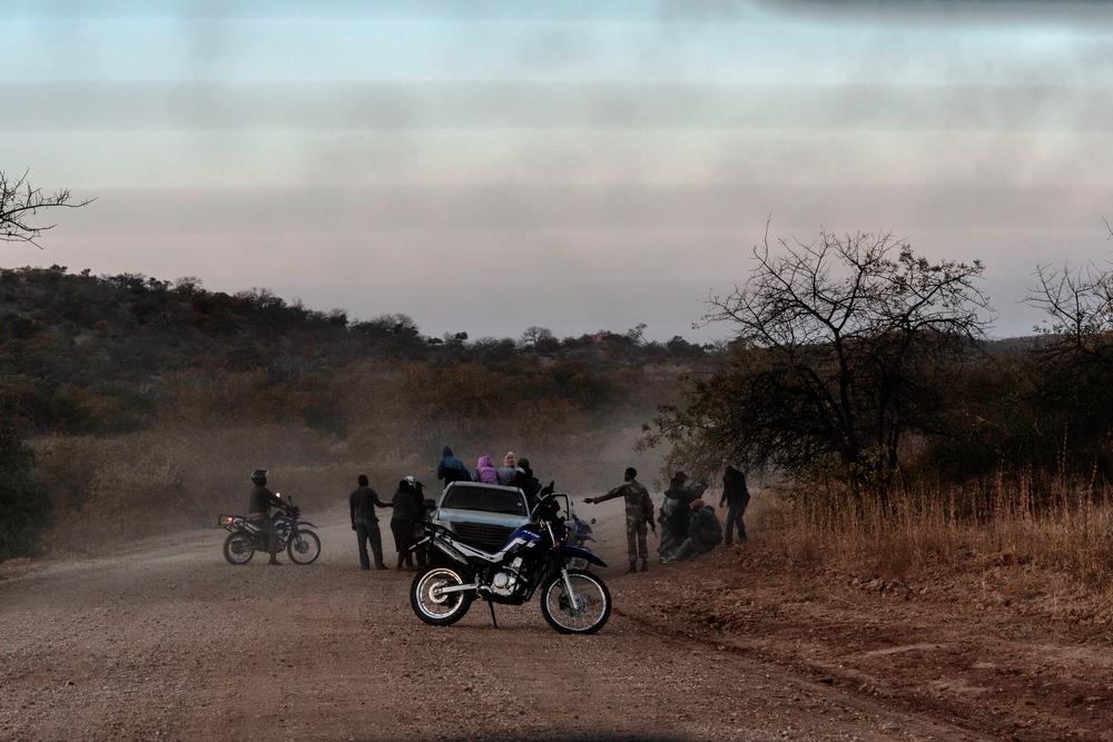 A picture of South African soldiers detain a group of people suspected of having illegally crossed into South Africa at the border between South Africa and Zimbabwe. 