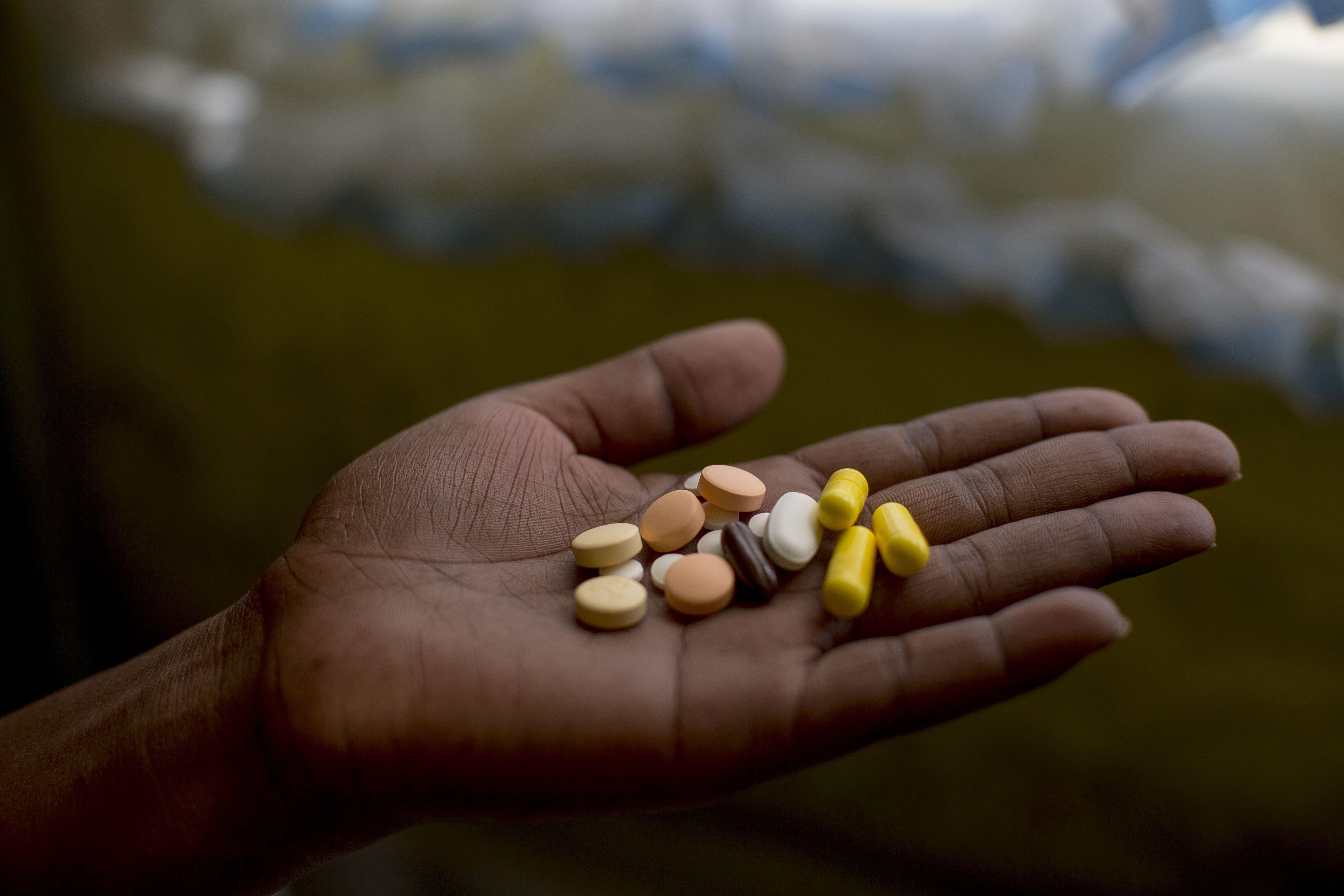 Patient Nanyanyiso Baloi holds her treatment regimen for pre-XDR-TB, which includes delamanid and bedaquiline. Khayelitsha, Western Cape.