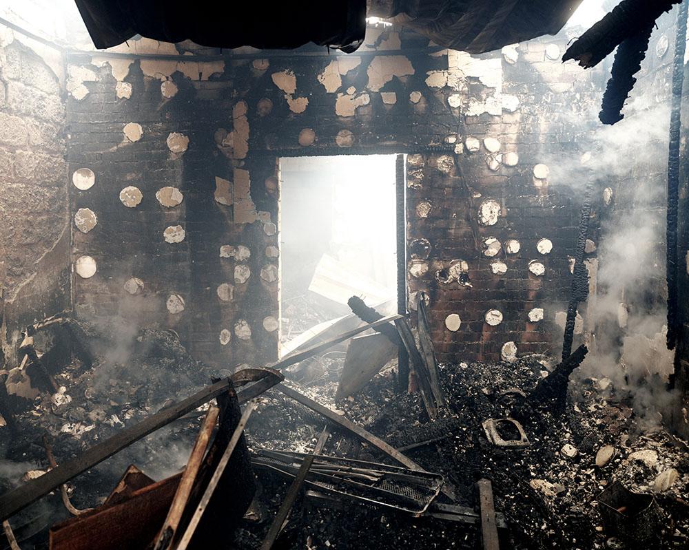UKRAINE, Mariupol. 24 February 2022. Burning civilian houses were hit by a rocket. MSF has been working in eastern Ukraine for the last eight years, trying to improve access to health care for remote, conflict-affected populations.
