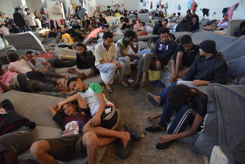 An image of a group of refugees in Zintan DC in the main warehouse where 700 of them are being detained.