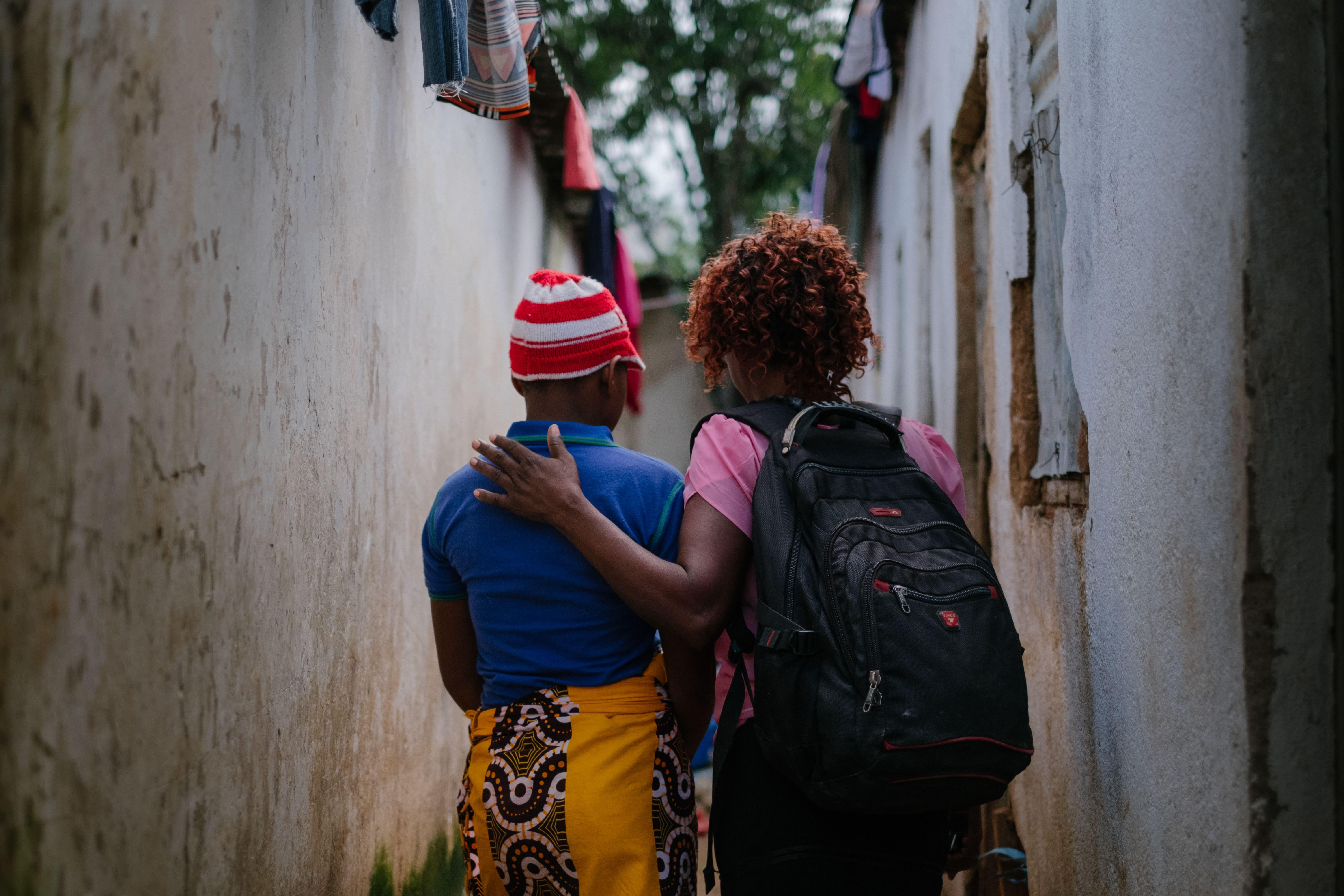 MSF community Health worker Rozi* interacting with one of the sex workers behind a bar hotspot in the centre of Mwanza town