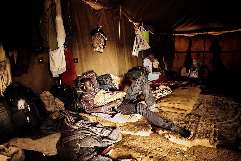 A picture of a migrant resting in a tent at a temporary shelter where migrants entering South Africa through Musina take refuge.