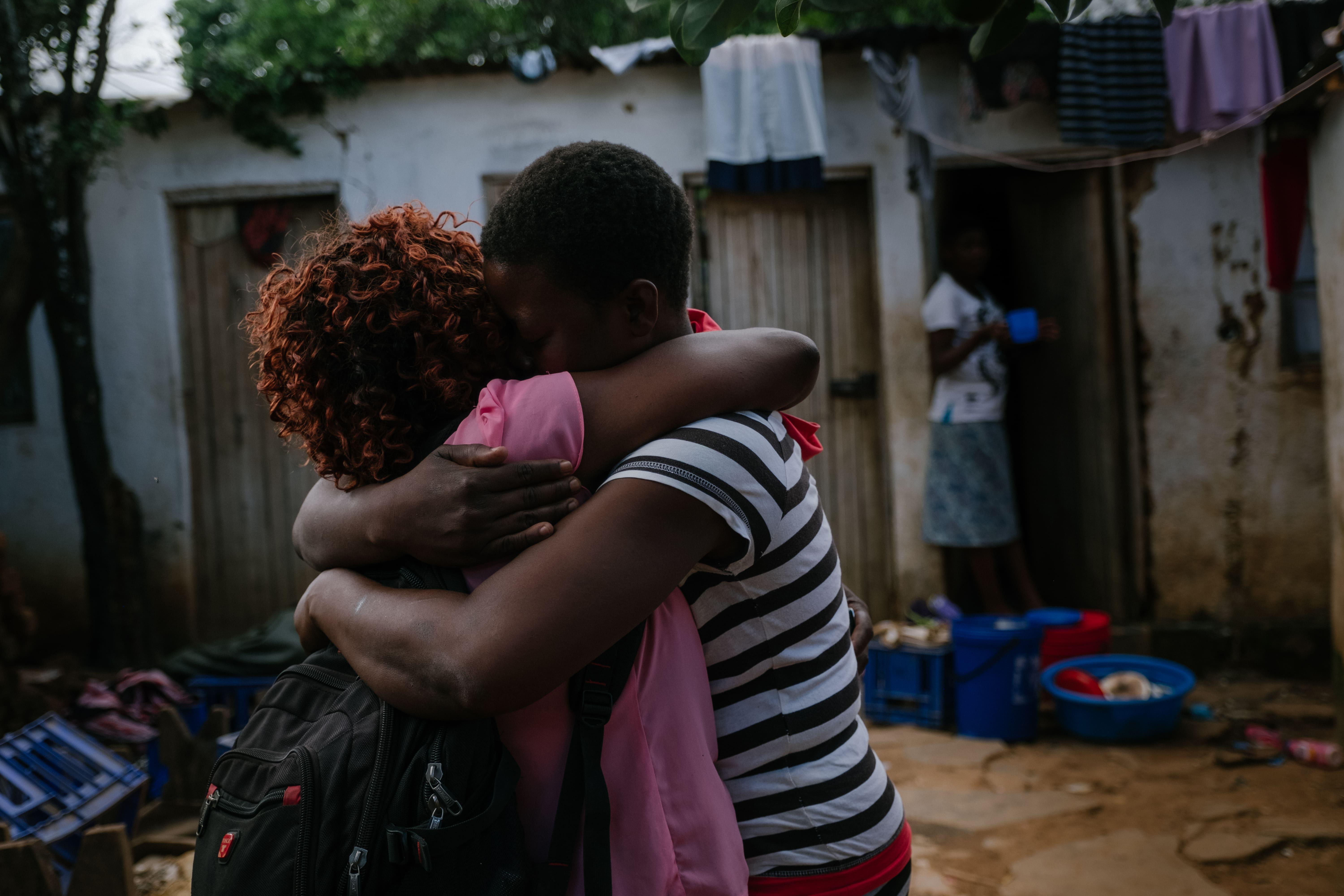 Rozi (not her real name) an MSF community health worker is being welcomed with a huge hug by one of the sex workers.